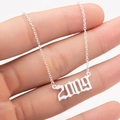 Detailed view of silver Gothic 2009 year pendant necklace showing size and scale - 2009 / Steel