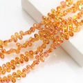 Close-up of faceted amber crescent crystal pendants for DIY jewelry and necklaces - Gold Rose Red
