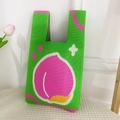 Cute green knitted tote bag featuring a pink peach pattern and twin handles - Green Peach