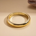 Close-up of a thick gold geometric bangle with a mirrored finish on a beige textured cloth - Gold Polished Circle