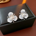 Macro detail of silver flower earrings with crystals and pearl on a black jewelry box - Silver Earring Post-Blue