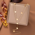Elegant gold double-layered heart necklace displayed on a warm brown jewelry box - Heart Double Layer Chain / Gold