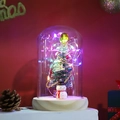 Close-up of LED glass dome featuring a Christmas tree and snowman on a wooden base - Style 9