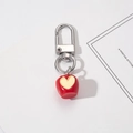 Red apple keychain with heart detail and silver lobster clasp on white background - Heart Apple