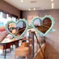 Kids heart shaped sunglasses with mint green wavy frames and dark lenses for fashion wear - Green