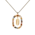 Macro detail of gold letter O pendant necklace with vibrant multi-colored zircon stones - Letter O