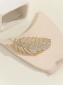 Detail view of a gold leaf brooch featuring micro-set sparkling zircon on its surface - Small Size / Gold Small Size