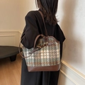 Retro plaid tote bag with brown leather trim shown on shoulder for autumn style - Green Check