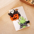 Close-up of Halloween hair clips featuring pumpkin pirate and green zombie hand shapes - Pirate Pumpkin and Zombie Hand Set