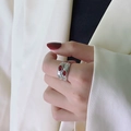 Macro view of vintage silver ring featuring dual oval red ruby stones and wide band - Double Red Zirconia Silver