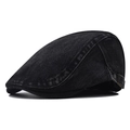 Detail of black washed denim beret featuring a vintage bronze adjustable side buckle - Black Denim