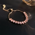 Macro shot of pink gemstone flower bracelet with golden adjustable chain and rainbow flare - Gold Pink Gemstone Style (47#)
