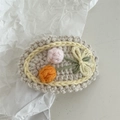 Detail of handmade crochet floral hair clip featuring pink flowers and a yellow bow - Crochet-Orange Pink Flower Bouquet