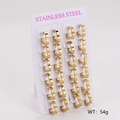 Set of 12 pairs of golden stainless steel heart hoop earrings displayed on a white card - Large (18*15mm)