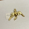 Polished gold-plated peace dove brooch with olive branch on a beige fabric background - 48 Gold Peace Dove (Z-4032)