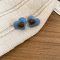 Detailed macro view of heart-shaped blue denim earrings with small brown resin heart accents - Denim Blue