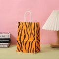 Detailed view of orange and black tiger stripe paper gift bag with white handle - Tiger Print / H21*L15*W8CM