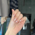 Detail showing press-on nails with red and white polka dot patterns on a nude base - By1589 Polka Dot Pattern / Glue Type