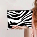 Handheld view of a zebra print canvas makeup bag with black zipper and metal puller - Classic Zebra Style (jiayingpbb0153)