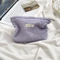 Lavender purple textured pouch for cosmetics on a minimalist desk setup with a metal basket - Light Purple