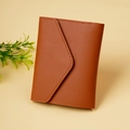 Detail of a brown leather envelope wallet showing pebbled texture and stitching accents - Light Coffee