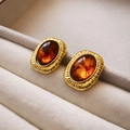 Vintage gold-toned square resin earrings with amber tones and pleated metal texture - Coffee Oval