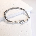 Detail view of silver beaded bracelet with irregular pearls and hollow butterfly charm - Butterfly / Steel