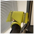 Detailed view of neon green geometric underarm bag with silver chain and leather handle - Green