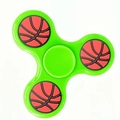 Detail of green three-leaf fidget spinner with basketball pattern weights on white background - Classic Green Basketball Pattern