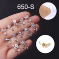 Detailed close-up of 12 assorted stainless steel L-shaped nose studs with zirconia - Flower Design (1#) / Silver