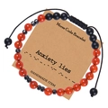 Detail of Morse code bracelet with red and black beads on a Kraft gift card - Anxiety Lies