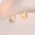 Elegant gold hollow heart earrings with micro-set zircon accents on silk background - Golden Hollow Heart Style (E0786)