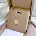 Detailed close-up of a golden titanium smile necklace with mother of pearl in a gift box - Gold/White Mother of Pearl (K323)