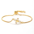 Detailed macro view of gold cross bracelet with zircon inlay and adjustable slide clasp - Style 4