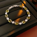 Close-up of vintage emerald cut green zircon bracelet with sparkling white stones - Green