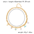 Detail of gold chain necklace with starfish, shell pendants and baroque pearl charms - Necklace / Gold