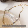 Close-up of beaded necklace with 40cm chain and lobster clasp on ceramic plate - Gold Brown Handmade Beaded Style (2#)