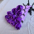 Eight purple soap roses individually wrapped with black ribbons on beige linen - Rose / Purple