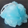 Light blue bamboo charcoal loofah shower ball with white hanging rope on wood background - 20g / Blue