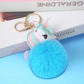 Blue faux fur pompom keychain with a colorful PU unicorn charm on a book background - Light Gold 4-Link Lobster Clasp / 8cm Bright Blue Unicorn