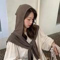 Dark brown knitted hooded scarf wrap for women shown on a model in outdoor setting - Khaki