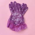 Detail of purple lace bridal gloves with ruffled wrists on a vibrant pink background - Kids One Size / Purple