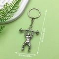 Silver dumbbell gym keychain with muscular lifter pendant and detailed size dimensions - Weightlifter