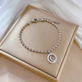 Macro view of stainless steel beaded bracelet featuring a star and moon paved pendant - Silver