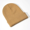 Detailed close-up of khaki acrylic knit beanie with classic ribbed cuff texture - Camel