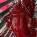 Red ceramic canister with attitude featuring black spots and a unique handle design - Red
