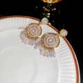 Macro detail of golden dreamcatcher earrings with pink gems and beaded tassels on a plate - 74# Pink Tassel