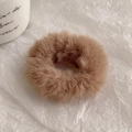 Close-up detail of soft fluffy brown plush hair scrunchie with thick velvet texture - Coffee