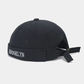 Detail view of Brooklyn embroidery on black canvas docker cap with adjustable strap - Black