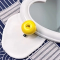 Realistic yellow apple hair clip with matte finish and black metal pin on blue tablecloth - Yellow Apple